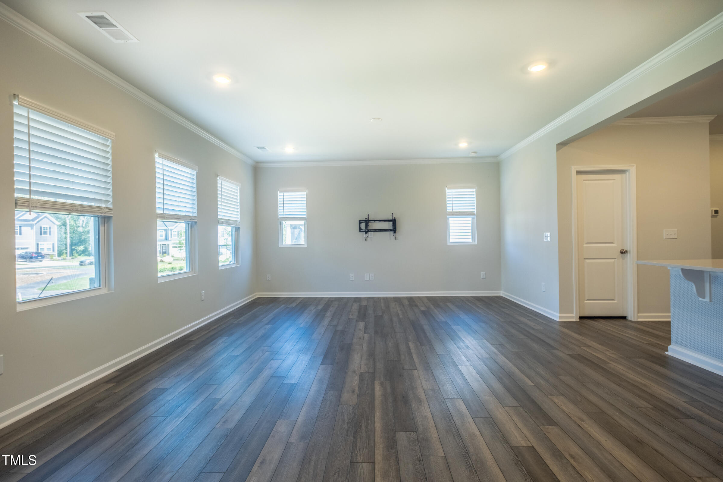 1726 Barrett Run Trail Apex, NC 27502 - Photo 27 of 50 an empty room with wooden floor and windows