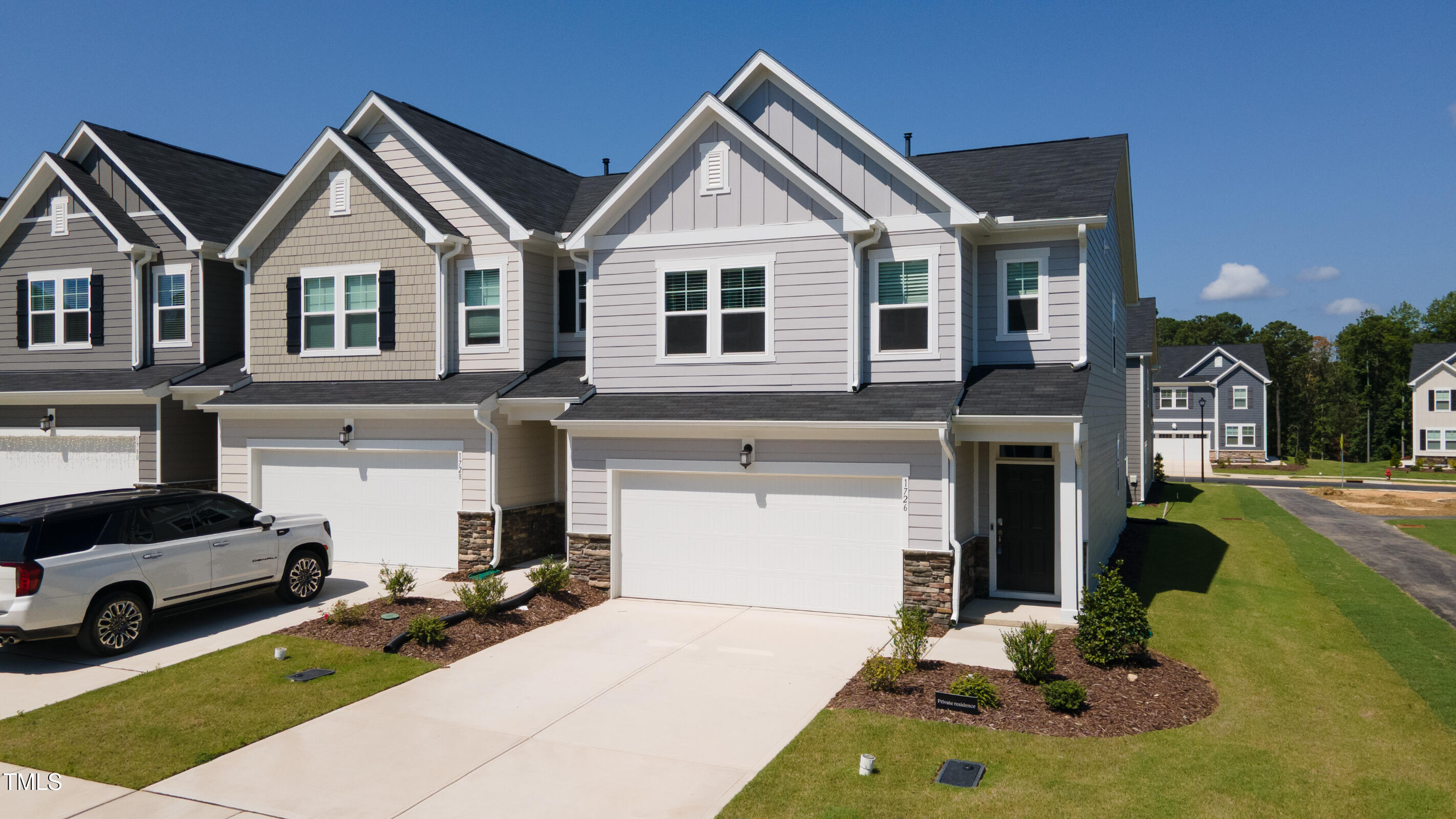 1726 Barrett Run Trail Apex, NC 27502 - Photo 3 of 50 a front view of a house with a yard and garage