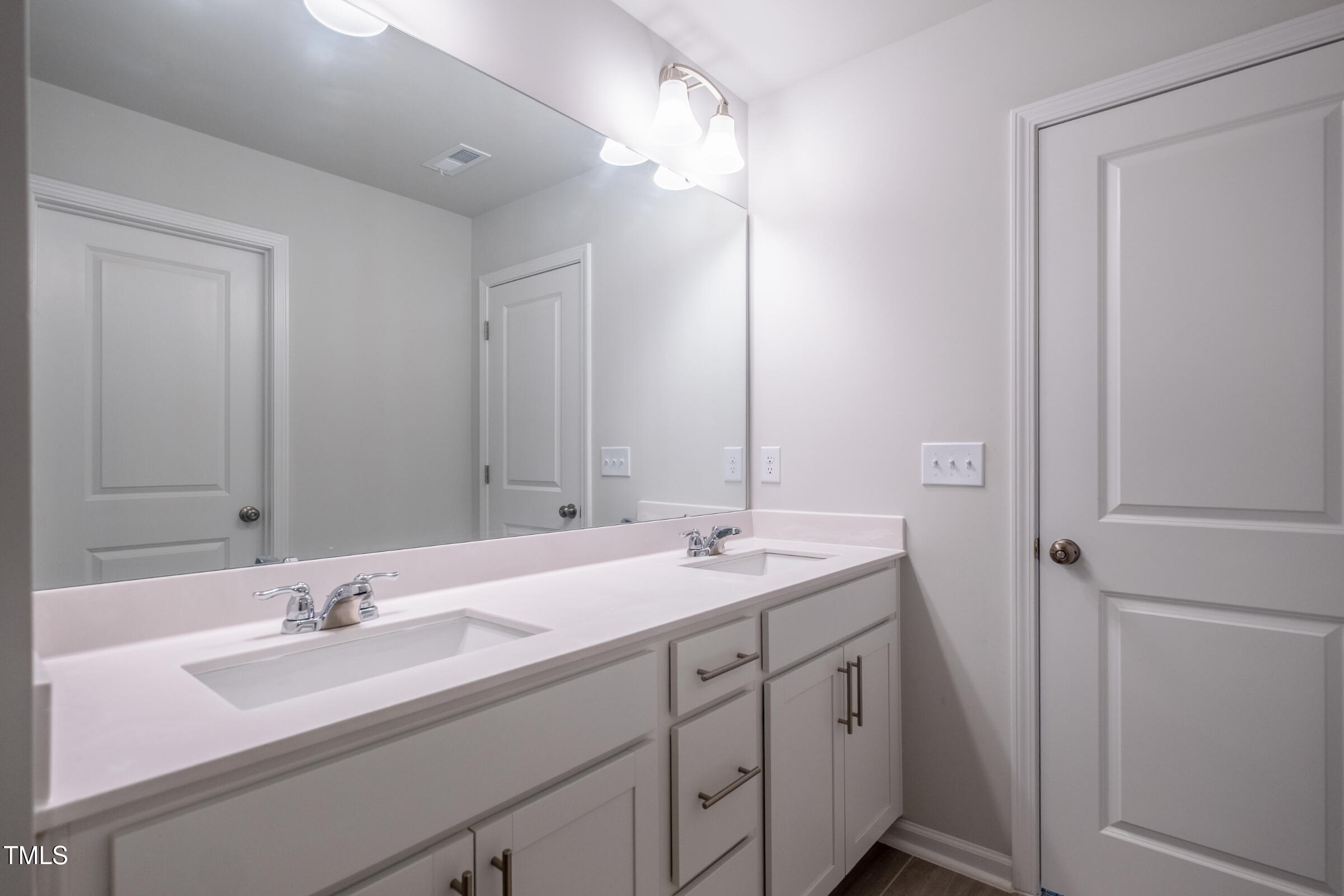 1726 Barrett Run Trail Apex, NC 27502 - Photo 33 of 50 a bathroom with a double vanity sink and a mirror