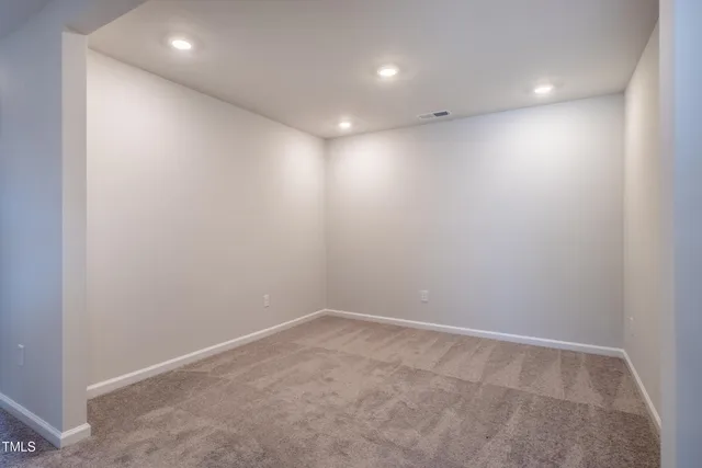 an empty room with closet and a bathroom