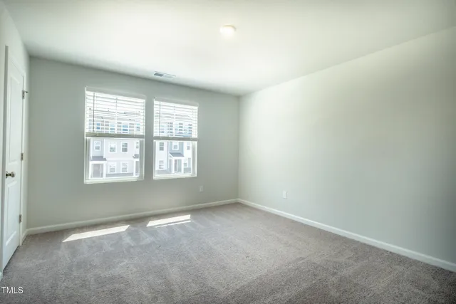 a view of an empty room with closet area