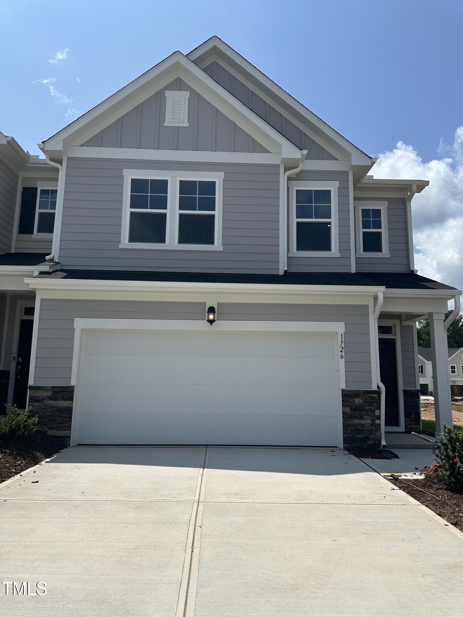 1726 Barrett Run Trail Apex, NC 27502 - Photo 4 of 50 a front view of a house with a yard and garage