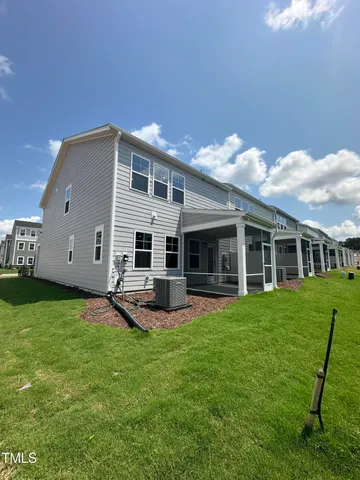 a backyard of a house with table and chairs