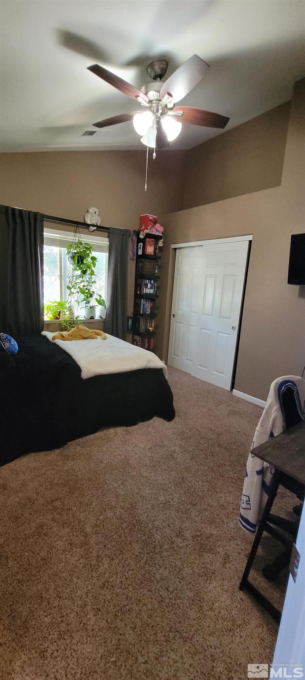 1921 Stargaze Way Reno, NV 89523 - Photo 17 of 26 a bedroom with a bed and a chandelier
