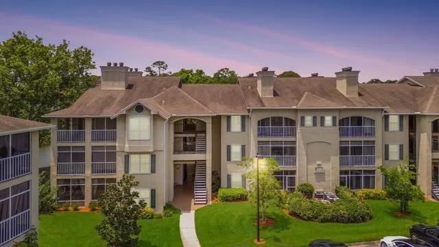 a front view of a residential apartment building with a yard