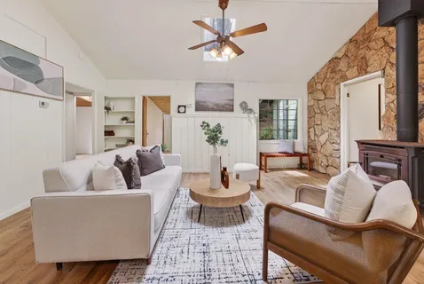 a kitchen sink sitting area with a view of living room