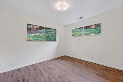 a view of a roof deck with table and chairs wooden floor and fence