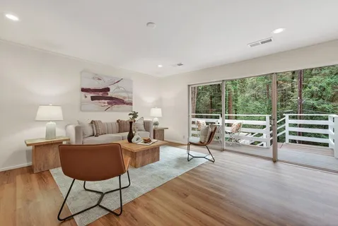 a living room with furniture and a floor to ceiling window