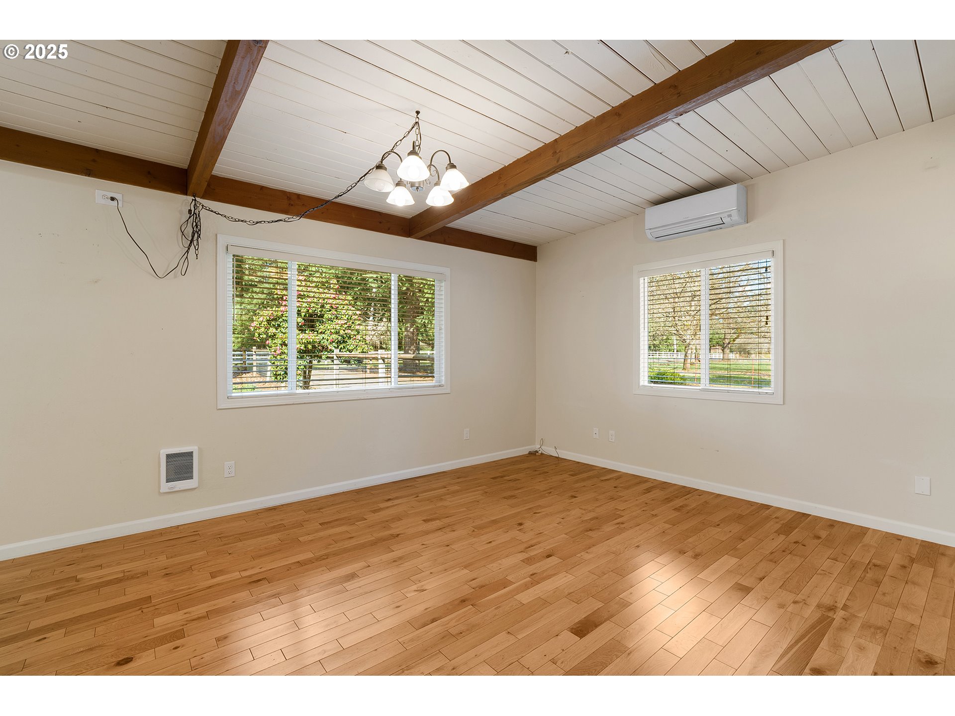 12950 South New Era Road Oregon City, OR 97045 - Photo 8 of 45 a view of an empty room with wooden floor and a window