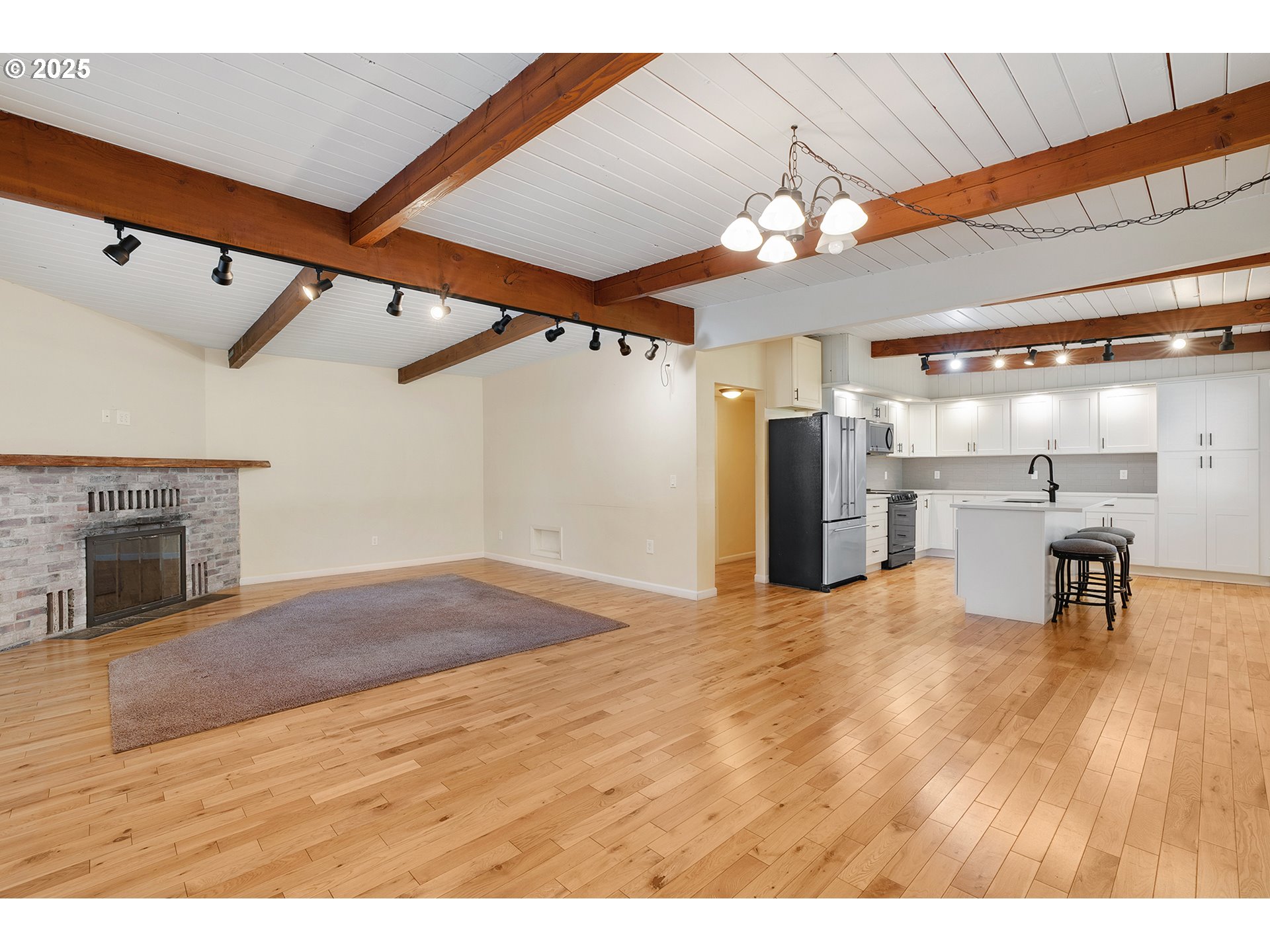 12950 South New Era Road Oregon City, OR 97045 - Photo 9 of 45 a view of a livingroom with a kitchen and a ceiling fan
