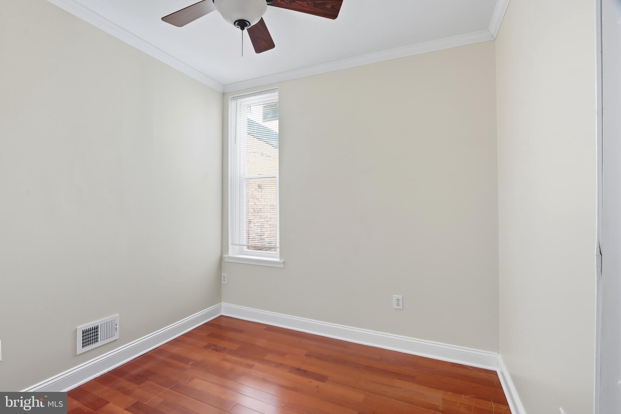 1314 James Street Baltimore, MD 21223 - Photo 14 of 19 an empty room with a window and ceiling fan