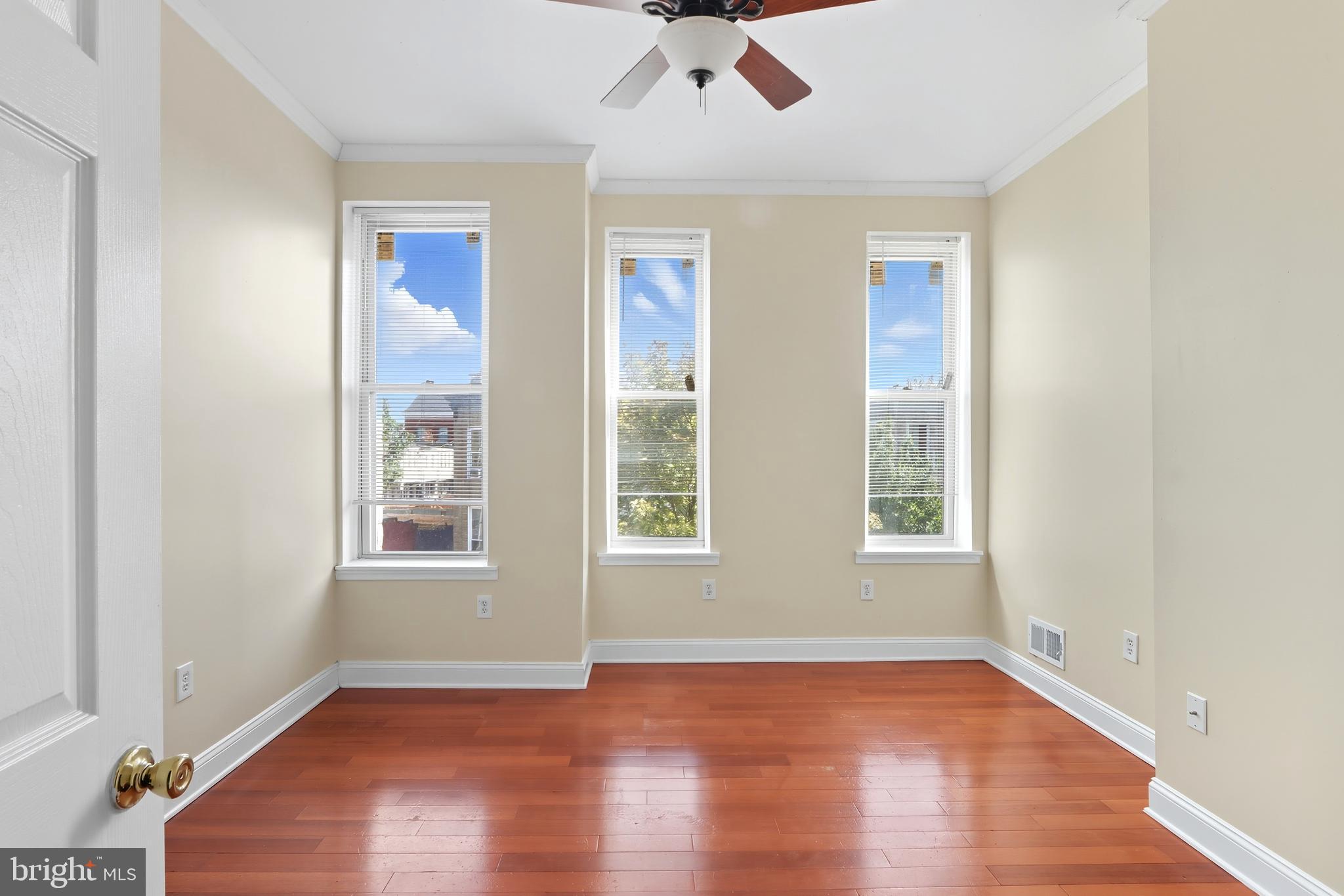 1314 James Street Baltimore, MD 21223 - Photo 17 of 19 wooden floor in an empty room with a window