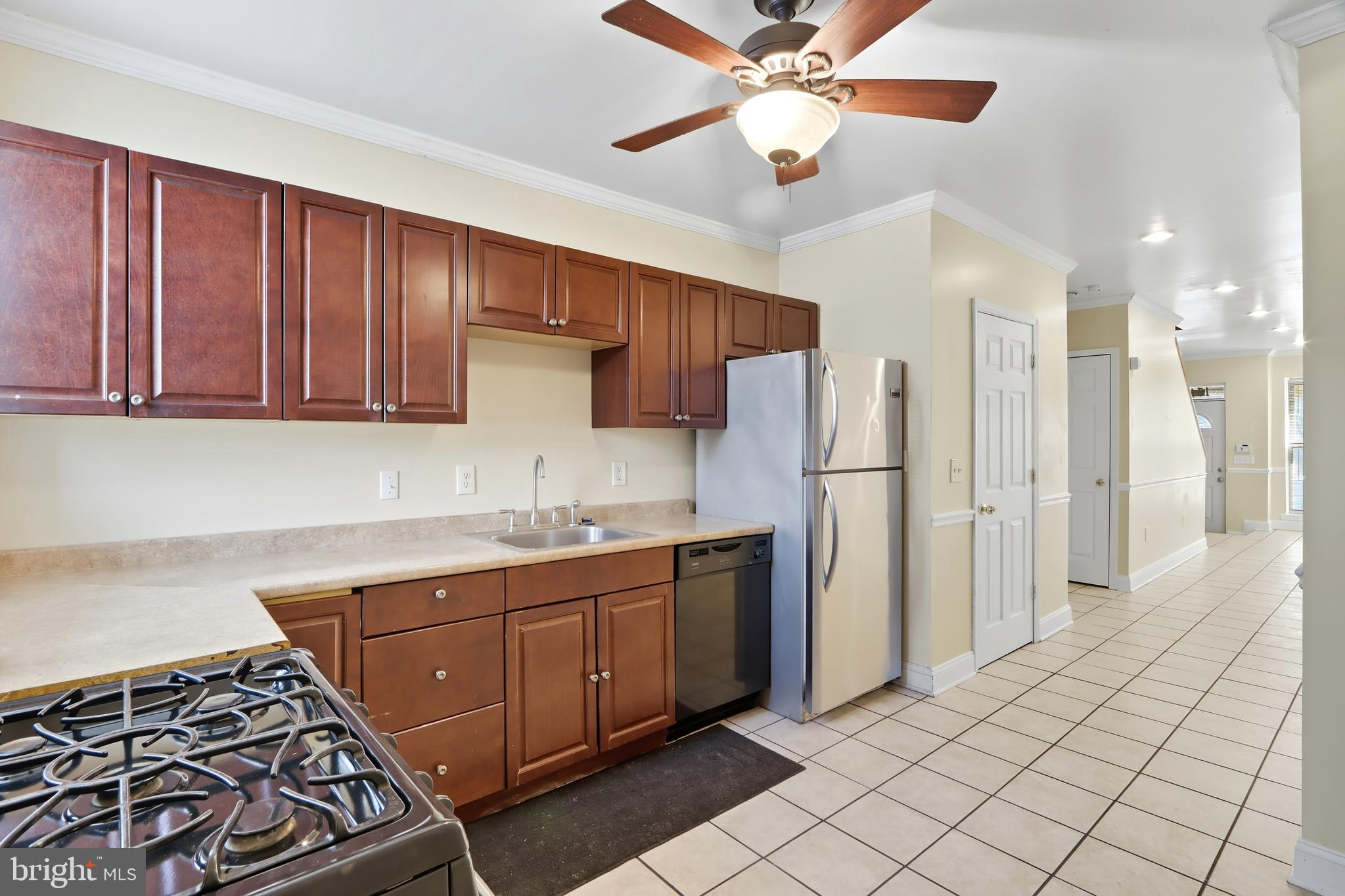 1314 James Street Baltimore, MD 21223 - Photo 10 of 19 a kitchen with stainless steel appliances a sink and a refrigerator