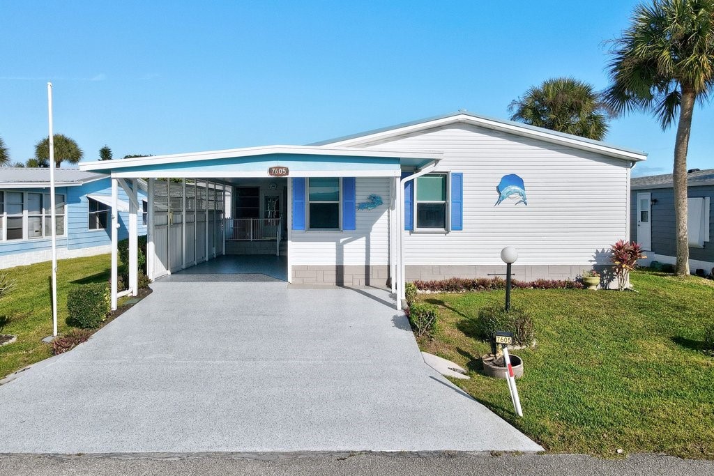 7605 Cedar Bark Road Sebastian, FL 32976 - Photo 2 of 34 a view of a house with backyard and sitting area