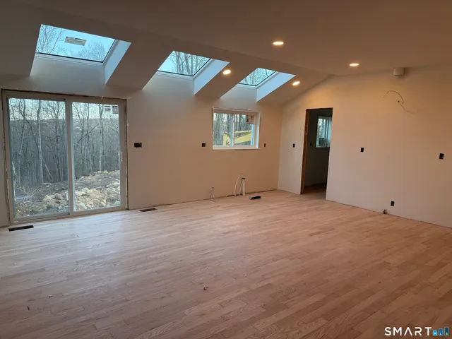 a view of an empty room with glass door