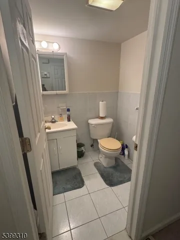 a bathroom with a sink toilet and mirror