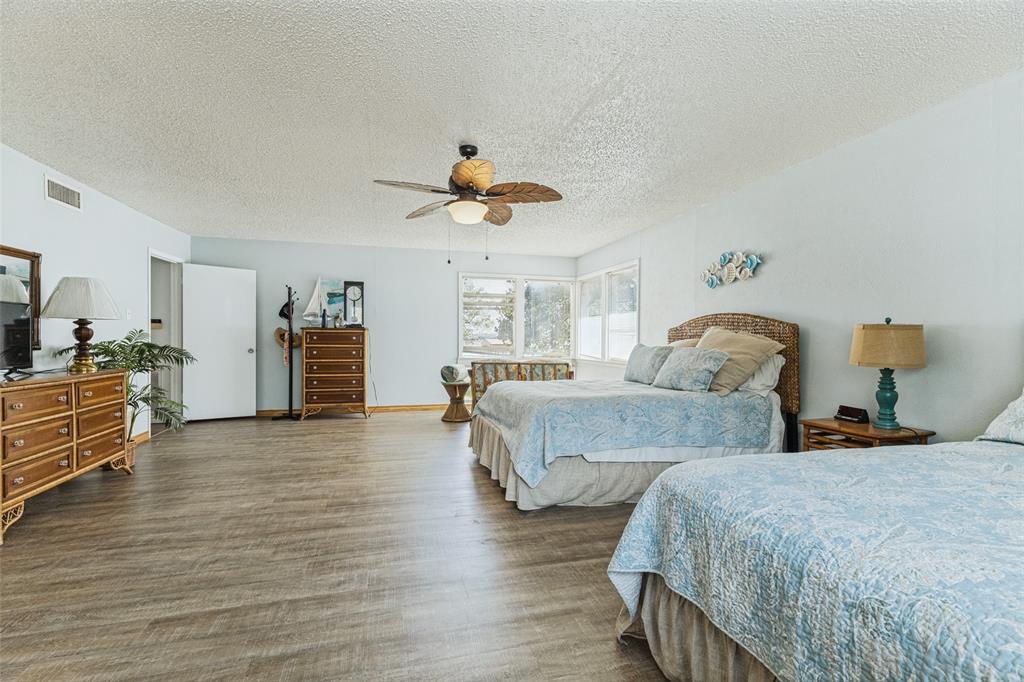 12960 Gantt Road East Azle, TX 76020 - Photo 17 of 26 Expansive room with wood-finish flooring, multiple windows, and a ceiling fan