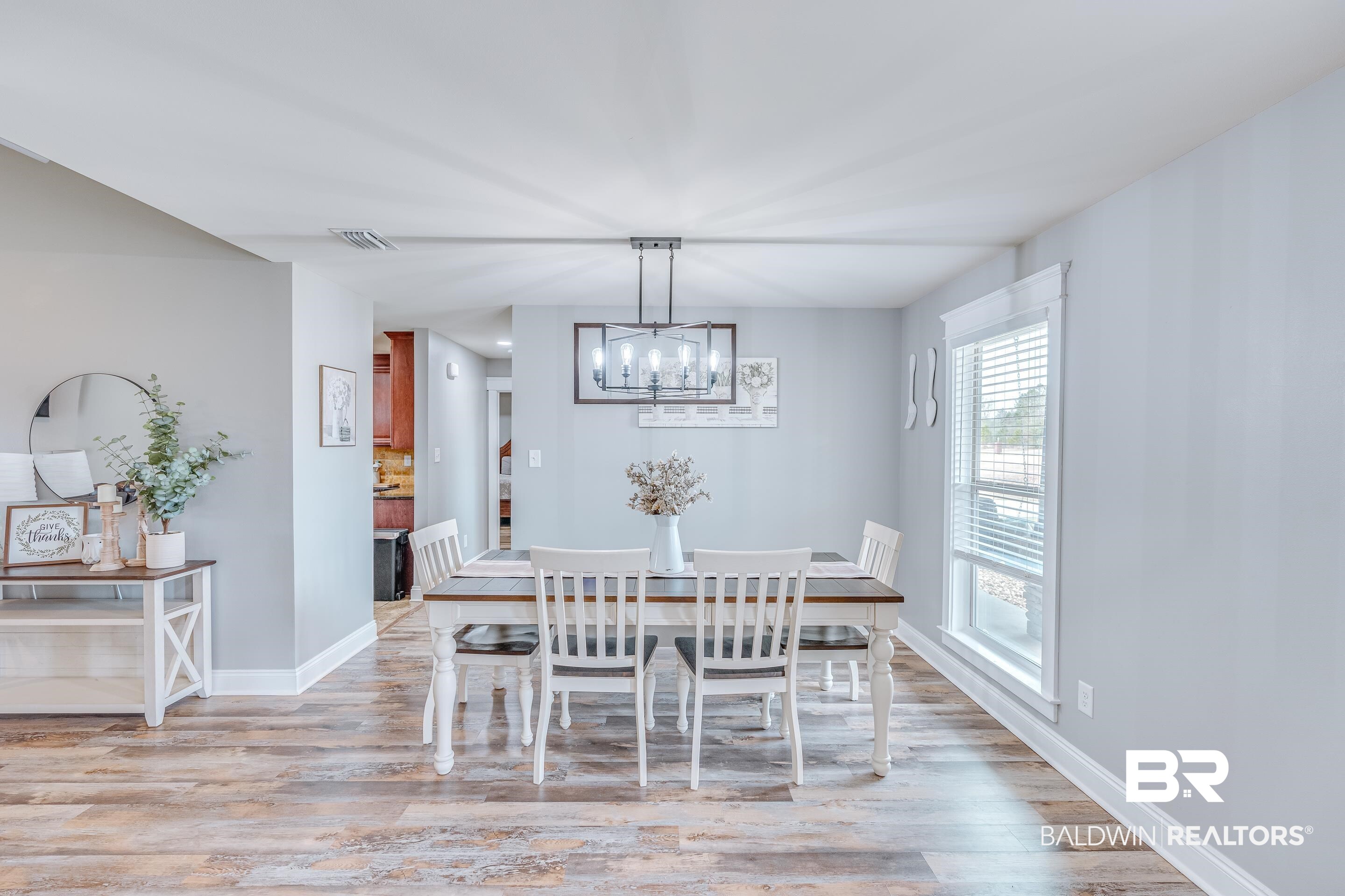 13235 Tom Gaston Road Mobile, AL 36695 - Photo 4 of 43 Dining space featuring a chandelier and light hardwood / wood-style flooring