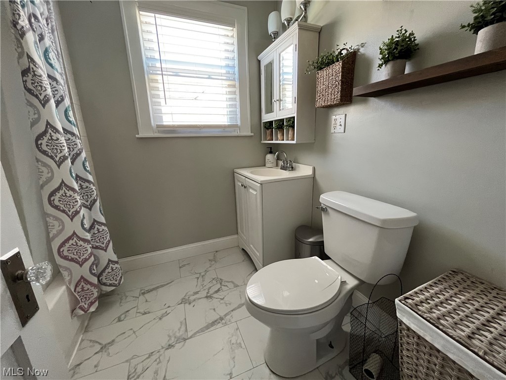 1902 Mathoit Street Parkersburg, WV 26101 - Photo 18 of 35 Full bathroom featuring shower / bath combo with shower curtain, oversized vanity, mirror, and light tile floors
