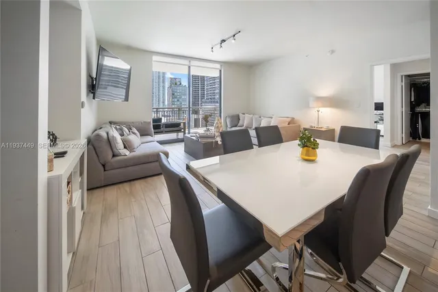 a view of a dining room with furniture and wooden floor
