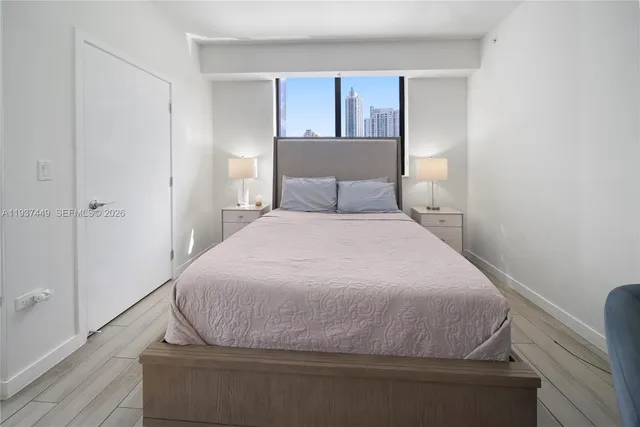 a bedroom with a bed and window