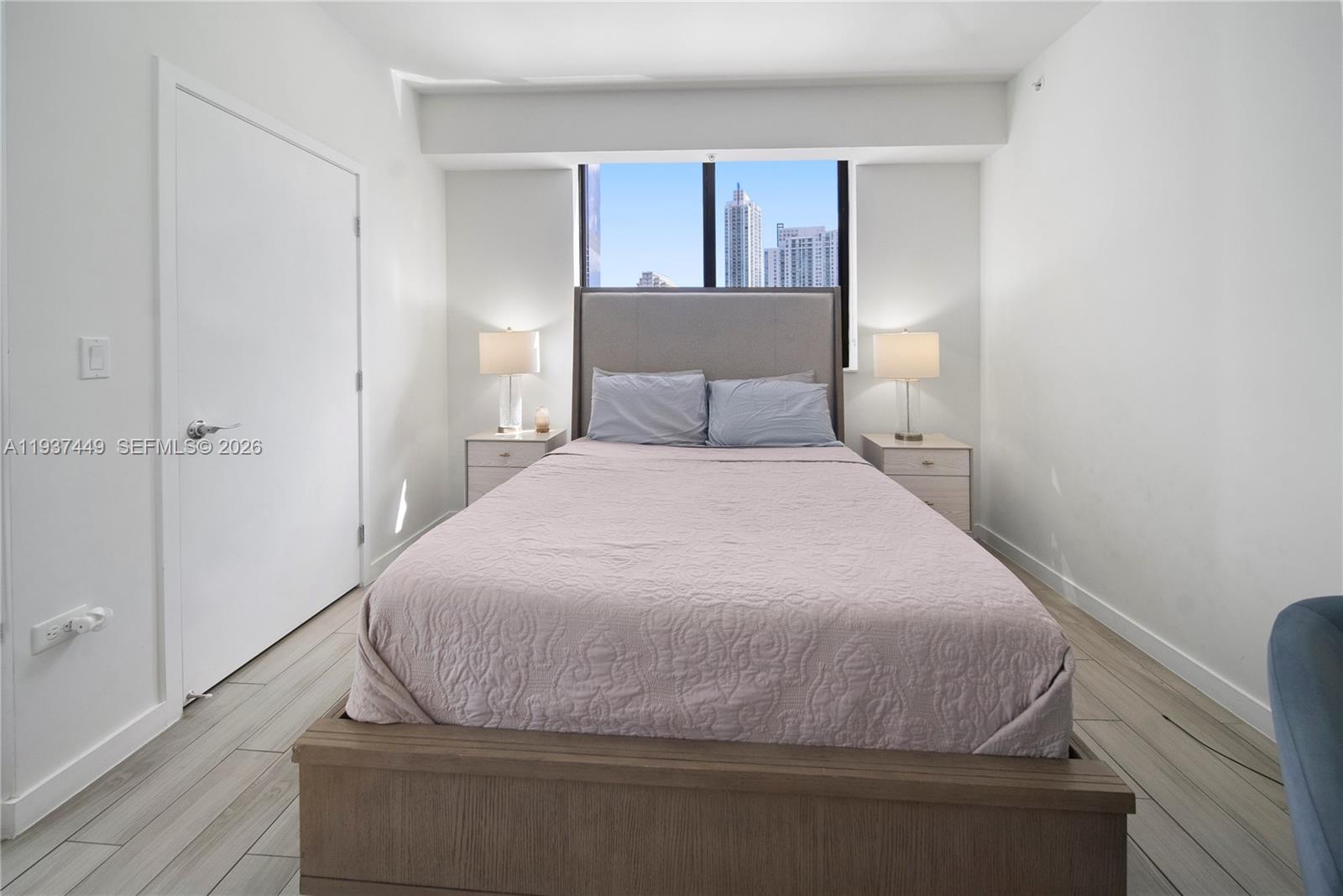 999 Southwest 1st Avenue, Unit 1617 Miami, FL 33130 - Photo 4 of 12 a bedroom with a bed and window