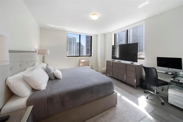 a bedroom with a bed and a flat screen tv