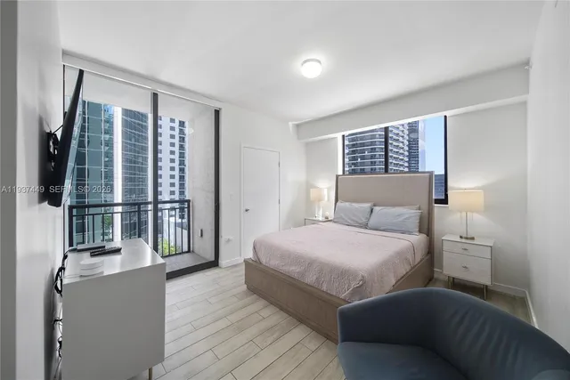 a bedroom with a large bed and a window