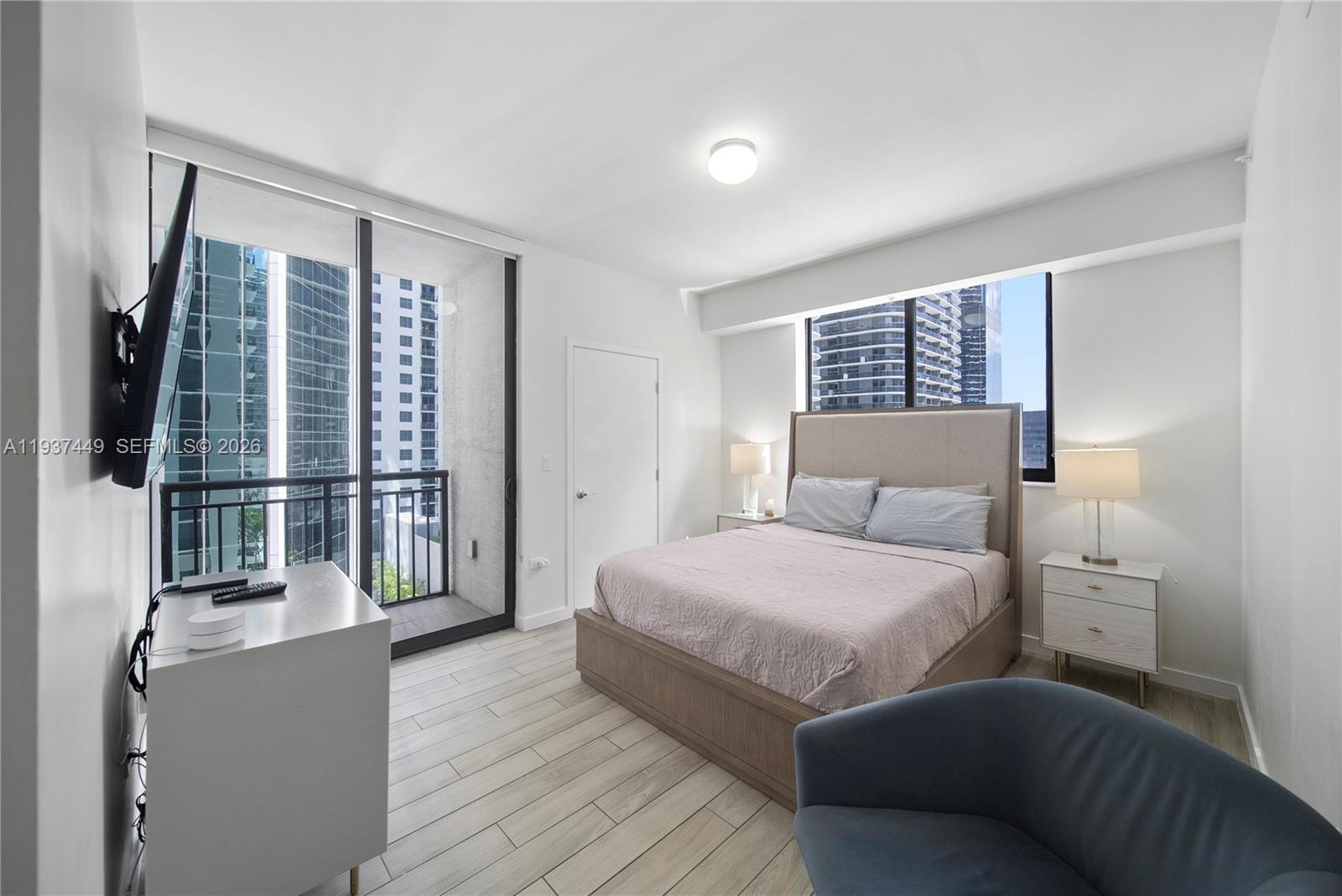 999 Southwest 1st Avenue, Unit 1617 Miami, FL 33130 - Photo 10 of 12 a bedroom with a large bed and a window