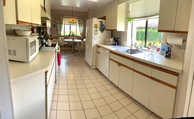 a kitchen with a sink appliances and cabinets