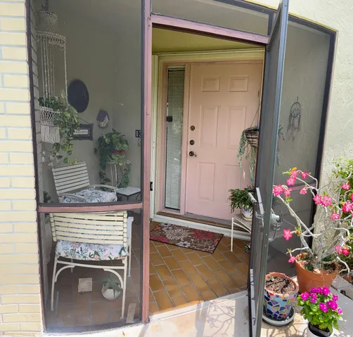 a living room with a fireplace and flowers