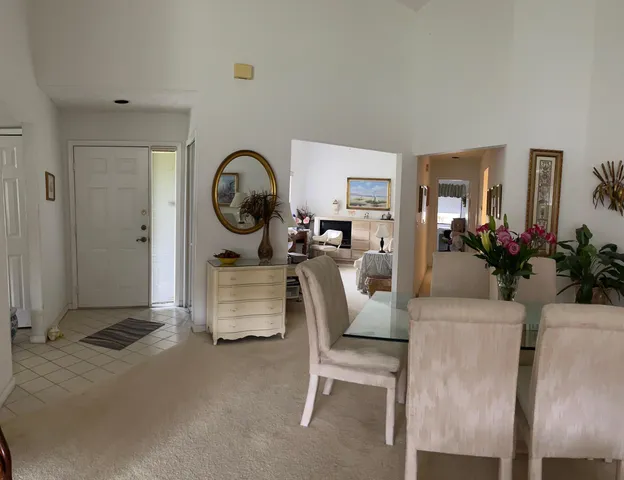 a living room with furniture a rug and white walls