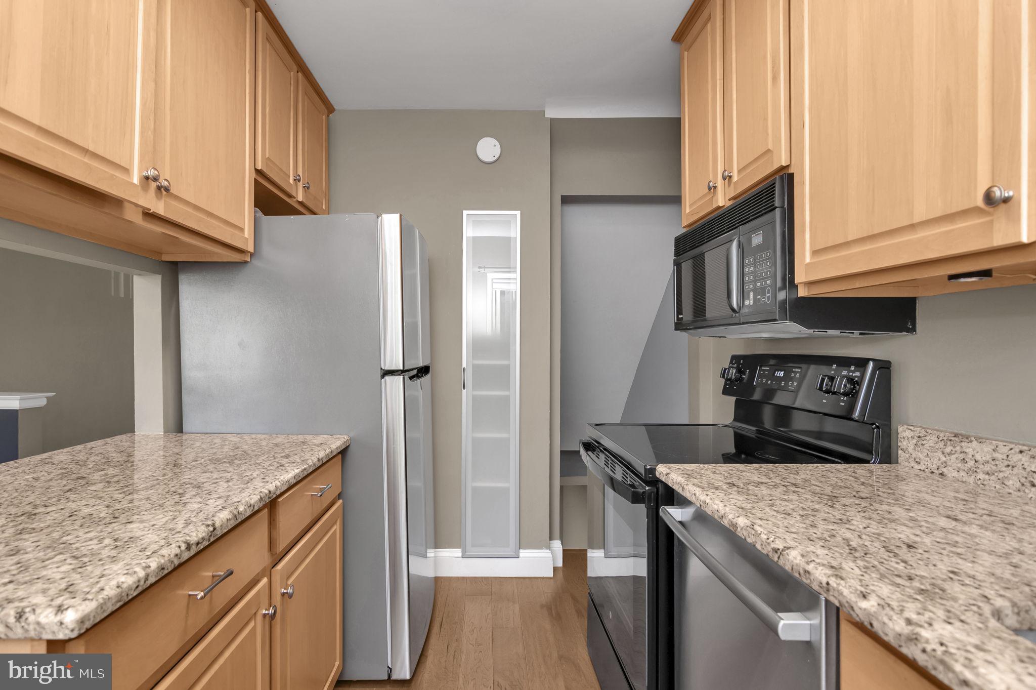 4237 32nd Road South Arlington, VA 22206 - Photo 14 of 49 a kitchen with stainless steel appliances granite countertop a refrigerator and a sink