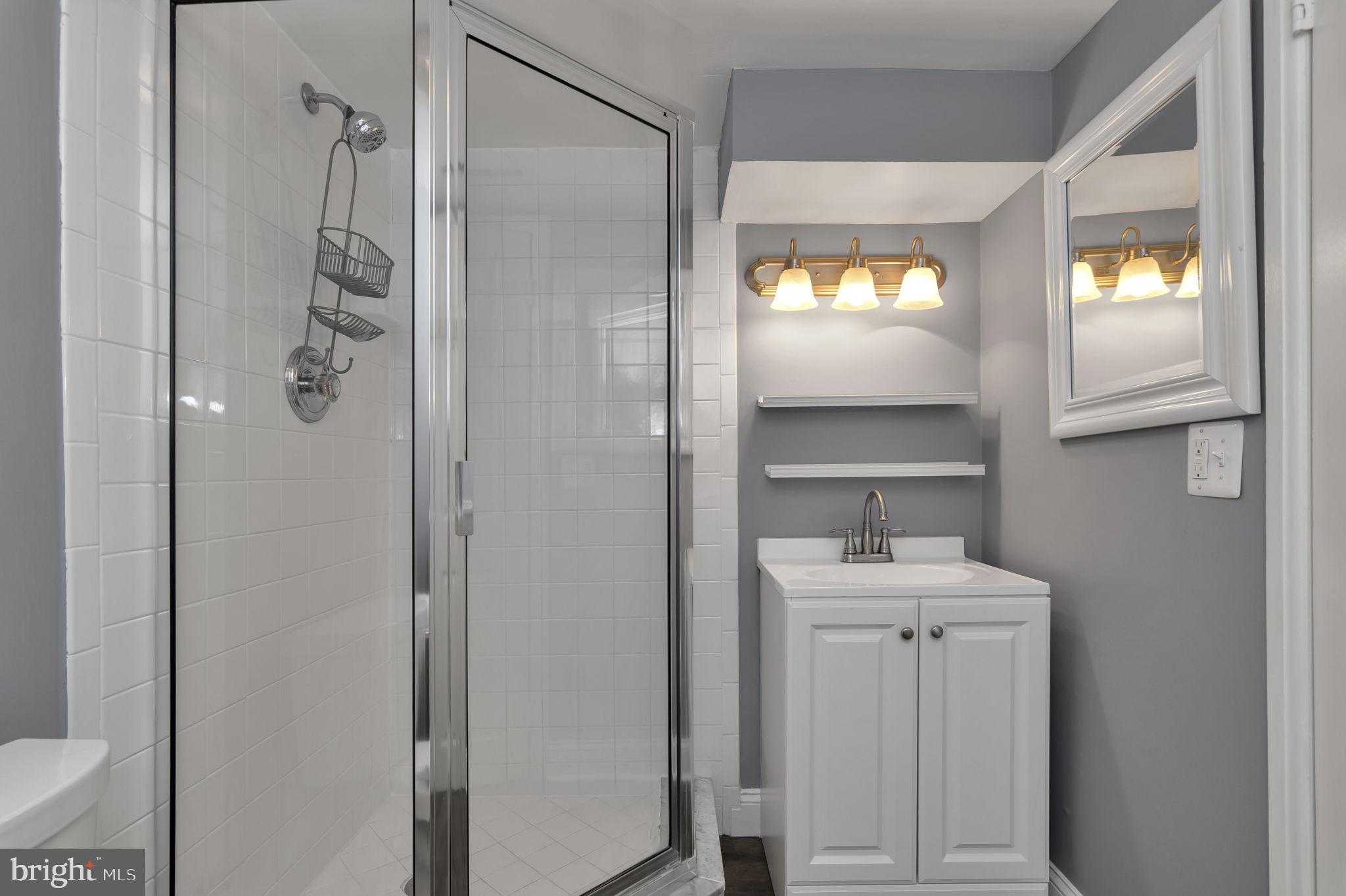 4237 32nd Road South Arlington, VA 22206 - Photo 26 of 49 a bathroom with a sink a toilet and shower