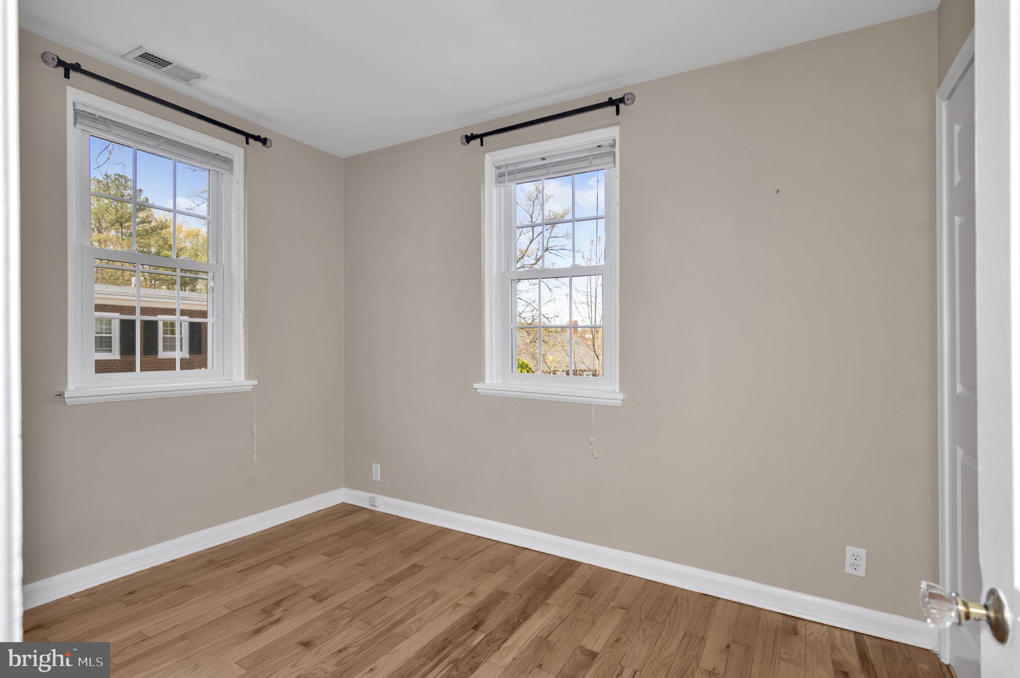 4237 32nd Road South Arlington, VA 22206 - Photo 31 of 49 a view of an empty room with wooden floor and a window