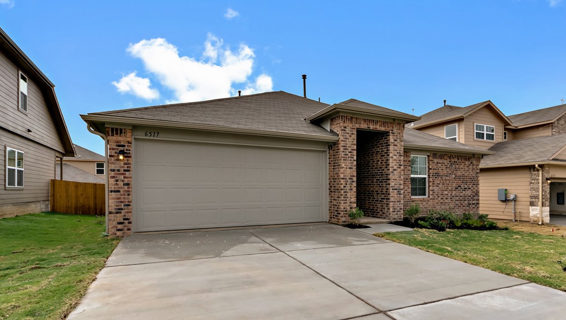 6717 Ranchito Drive Austin, TX 78744 - Photo 1 of 1 a front view of a house with a yard