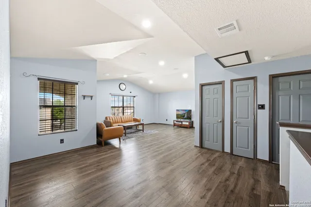 a living room with furniture and wooden floor