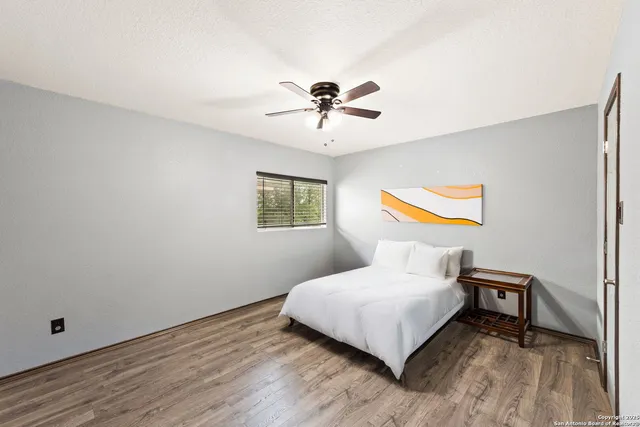 a bedroom with a bed and wooden floor