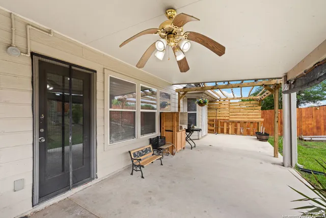 a view of a porch with a table and chairs