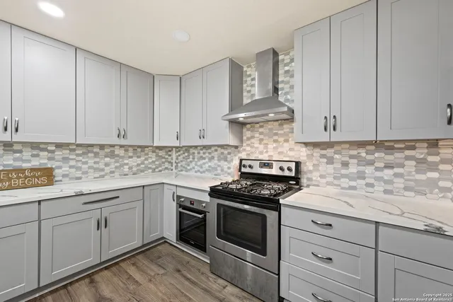 a kitchen with granite countertop white cabinets and white appliances