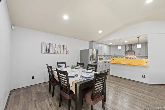 a view of a dining room with furniture and wooden floor