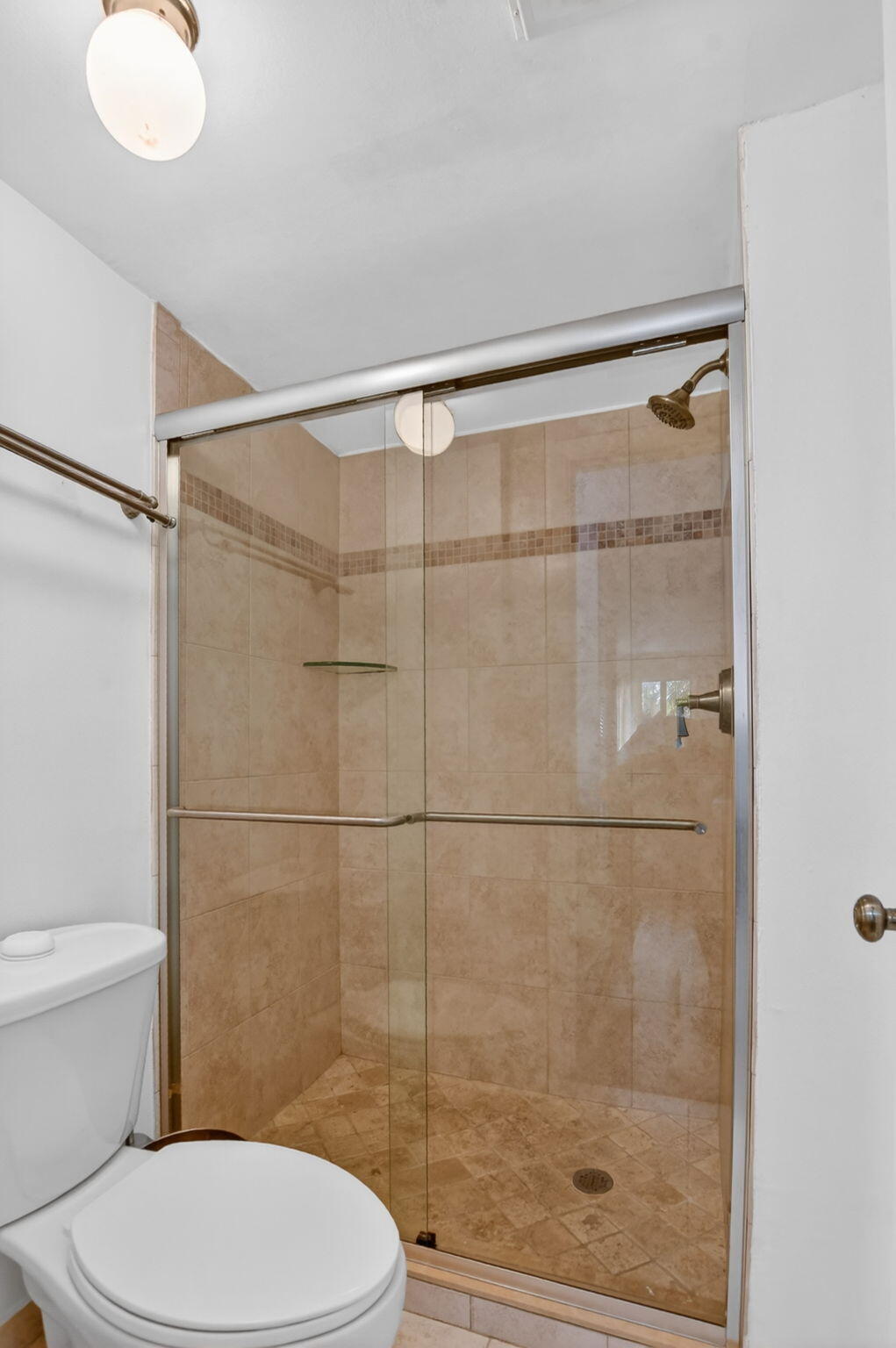 2297 Southwest 15th Street, Unit 127 Deerfield Beach, FL 33442 - Photo 18 of 39 a bathroom with a toilet and a shower