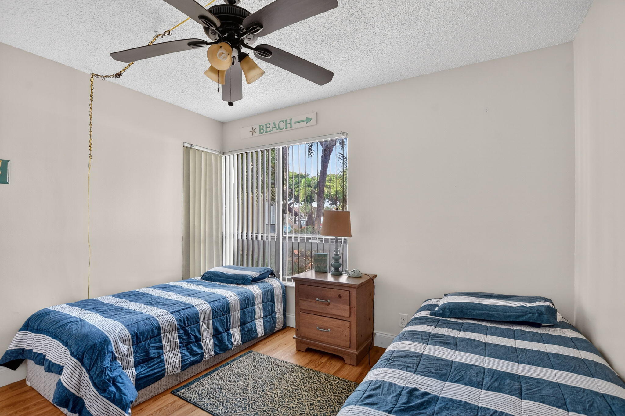 2297 Southwest 15th Street, Unit 127 Deerfield Beach, FL 33442 - Photo 20 of 39 a bedroom with a bed and a chandelier