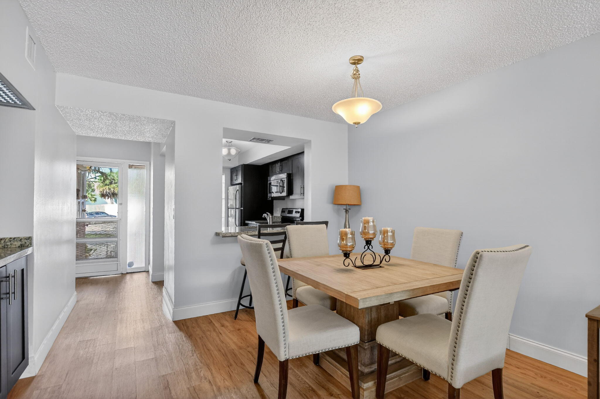 2297 Southwest 15th Street, Unit 127 Deerfield Beach, FL 33442 - Photo 5 of 39 a view of a dining room with furniture and wooden floor