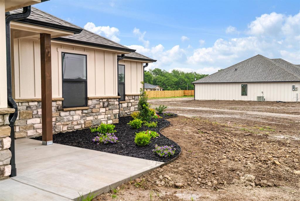 59 Private Road Brookston, TX 75421 - Photo 26 of 26 a front view of a house with a yard and potted plants