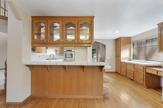 a kitchen with stainless steel appliances granite countertop a stove and a sink