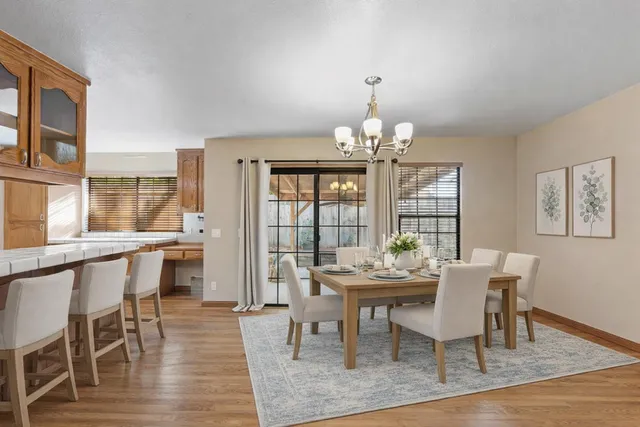 a view of a dining room with furniture wooden floor and chandelier