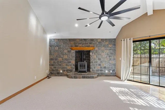 a view of a hallway with a fireplace and a window