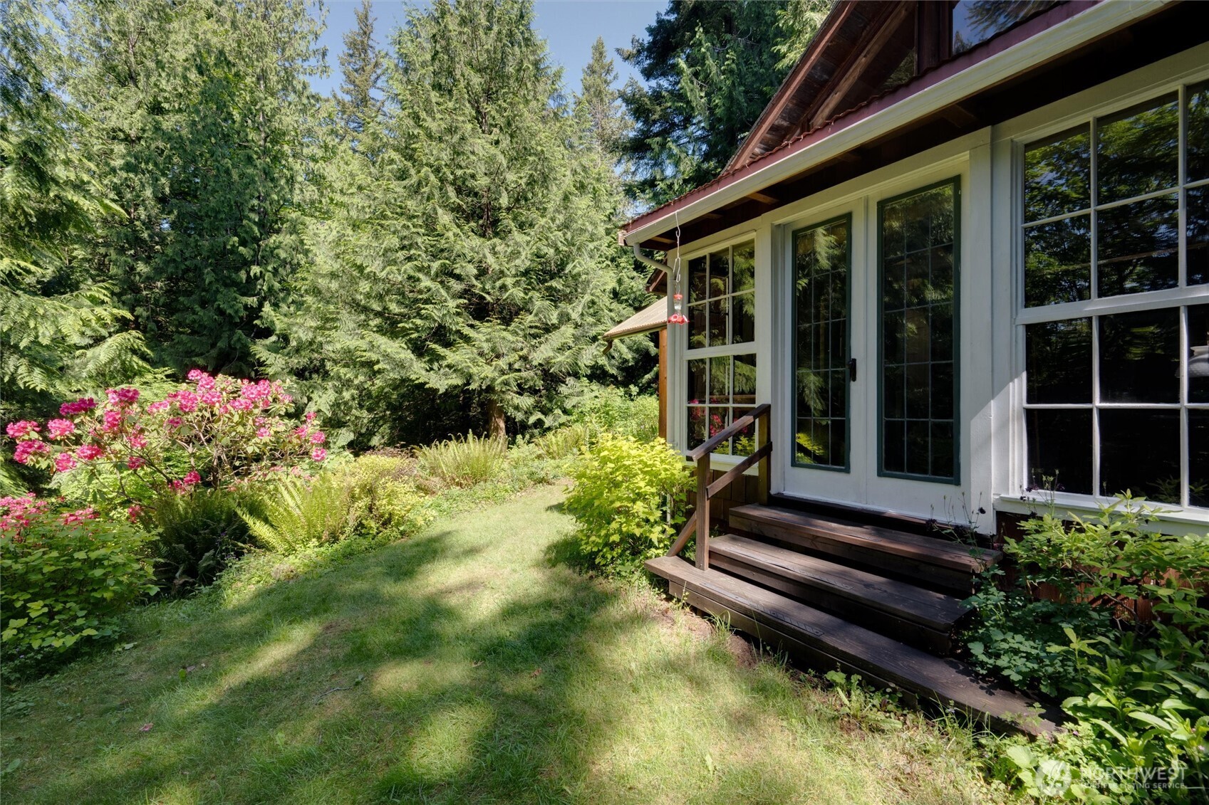 4315 Nordum Road Everson, WA 98247 - Photo 14 of 40 a view of a house with potted plants and a flower garden