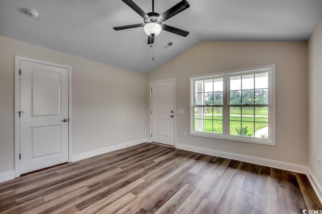 4911 Joyner Swamp Road Galivants Ferry, SC 29544 - Photo 2 of 28 Spare room with vaulted ceiling, ceiling fan, and hardwood / wood-style floors